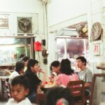 a group of people sitting at a table in a restaurant