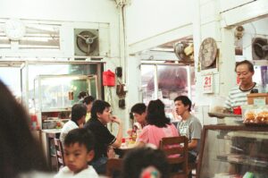 a group of people sitting at a table in a restaurant