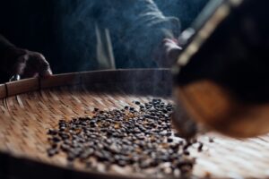 a close up of a person stirring coffee beans