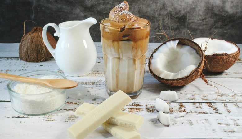 white ceramic pitcher beside clear glass pitcher on brown wooden table